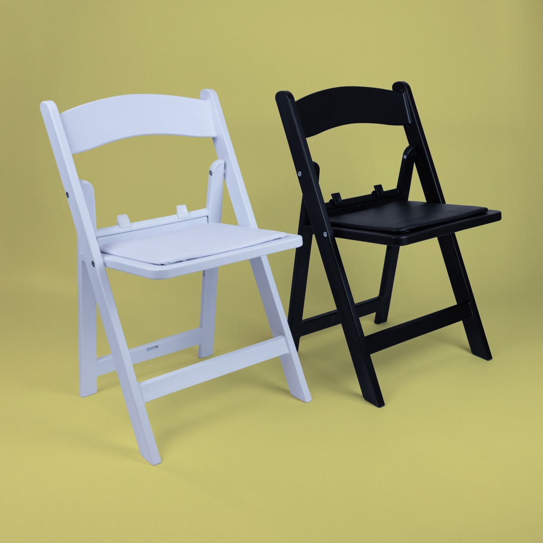 White and black Child Size Americana Chairs side by side on yellow background – miniature foldable event chairs made from UV-stabilised polypropylene with removable cushions for easy cleaning.