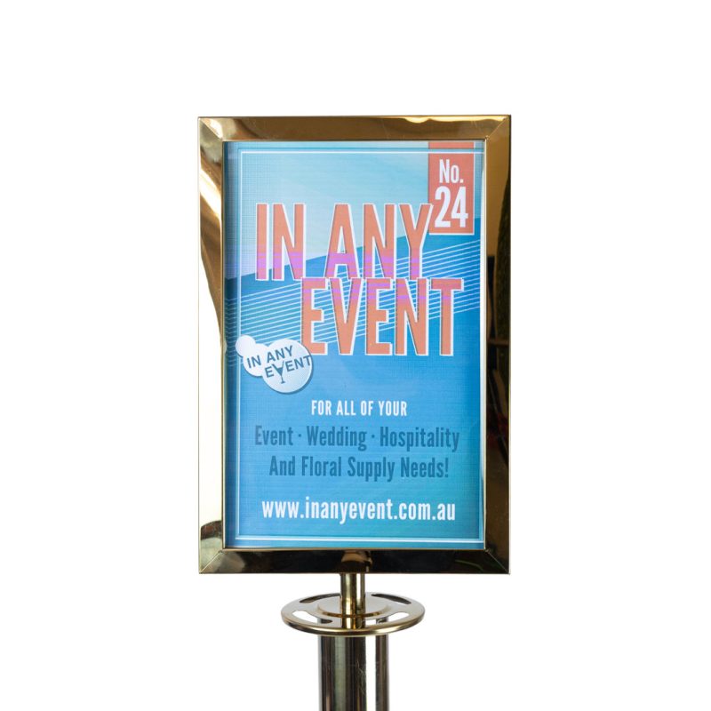 Close up gold A4 sign frame attachment mounted on stanchion post for velvet rope barrier crowd control system