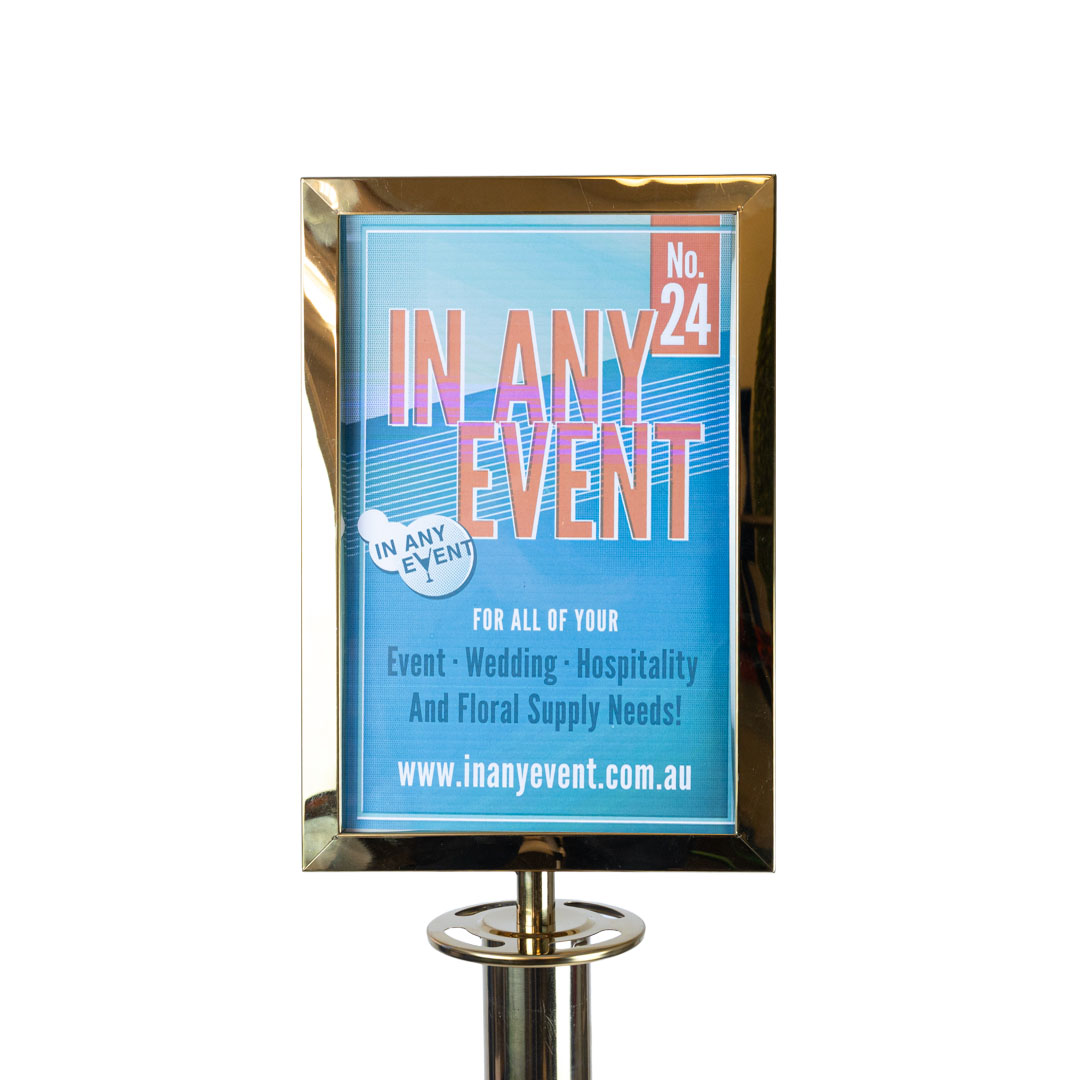 Close up gold A4 sign frame attachment mounted on stanchion post for velvet rope barrier crowd control system