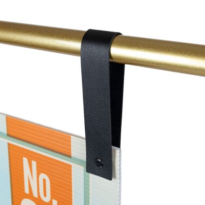 Close-Up of Black Faux Leather Sign Hangers on Gold Bar – Perfect for Event Signage and Shop Displays