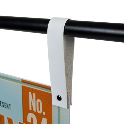 White Faux Leather Signage Strap Securing Event Sign on Black Metal Stand