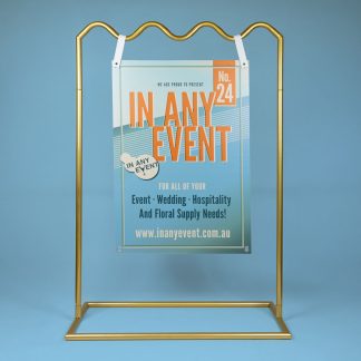 Gold Wave Signage Stand Displaying Event Sign on Blue Background - Ideal for Weddings & Corporate Events