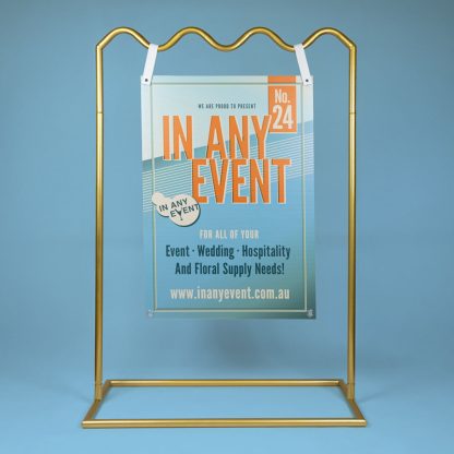 Gold Wave Signage Stand Displaying Event Sign on Blue Background - Ideal for Weddings & Corporate Events