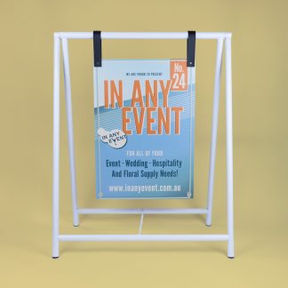 Freestanding white A-frame signage stand displayed against beige background with event sign attached.