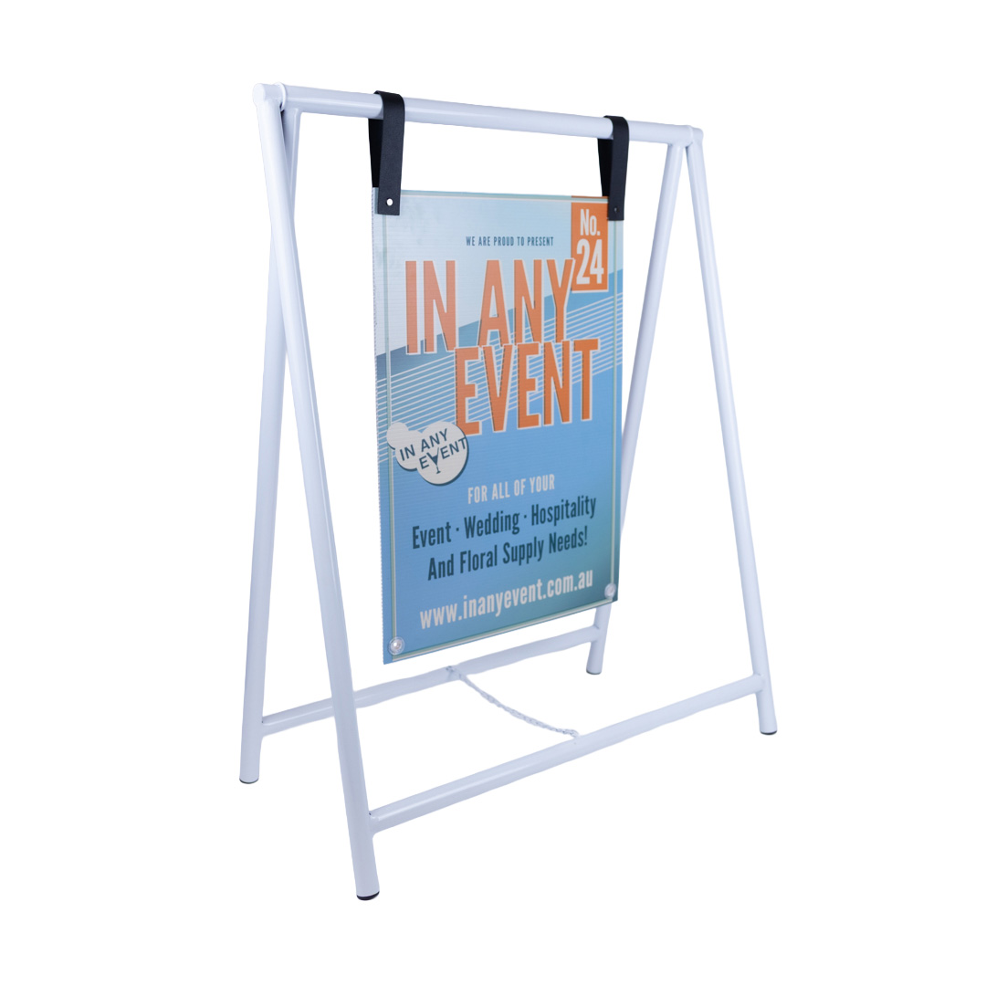 Angled view of white metal A-frame sign stand with event signage hanging from top bar using black straps.