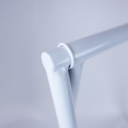 Close-up of welded joint on white metal A-frame sign stand showing smooth powder-coated finish and durable construction.