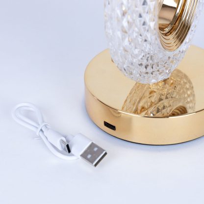 Cordless crystal LED lamp with gold base showing USB charging port and included USB cable