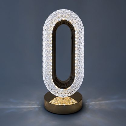 Gold oval crystal LED lamp displaying mixed colour temperature with decorative light pattern