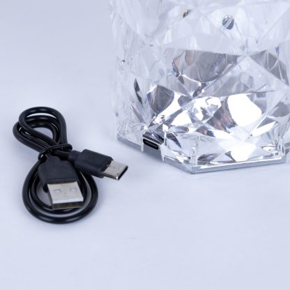 Close-up of the cordless crystal LED lamp base with USB charging port and included USB cable for rechargeable use.