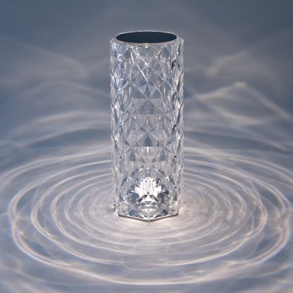 Crystal cylinder LED lamp turned on displaying stunning warm crystal light patterns creating ambient lighting for tables or events.