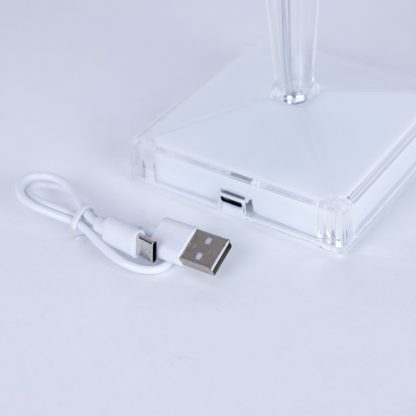 Close-up of rechargeable crystal table lamp base with included USB charging cable, highlighting cordless and portable design.