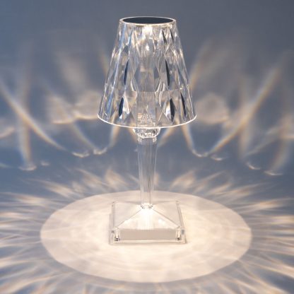 Crystal LED lamp projecting warm diamond light pattern on surface, creating elegant ambient lighting for events or home décor.