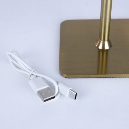 USB charging cable beside gold rechargeable LED touch table lamp – cordless metal lamp with convenient USB-C charging port.