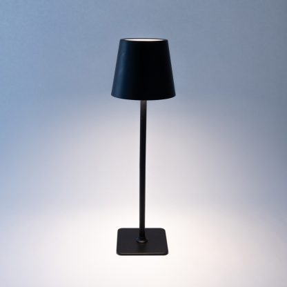 Black LED touch table lamp on, displaying warm white light – rechargeable metal touch dimmable lamp ideal for event or restaurant table lighting.