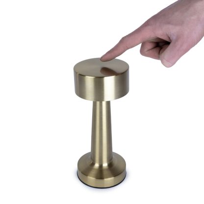 Hand demonstrating touch control on gold rechargeable mushroom table lamp for easy dimmable lighting