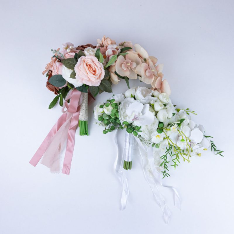 Artificial wedding bouquet set featuring white and ivory and pink and peach tear drop bouquets with satin and lace ribbons, ideal for bridal bouquet toss or bridesmaid toss bouquets.