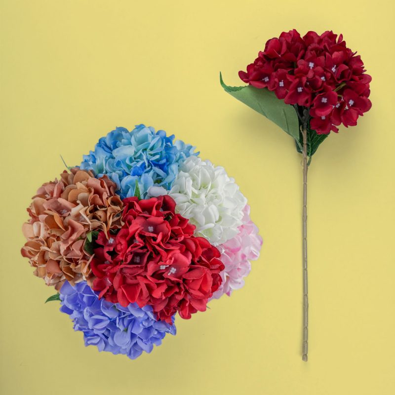 Assorted artificial hydrangea stems in pink, ivory, red, rust, blue, and purple displayed together, showcasing 45 cm faux hydrangea flower options.