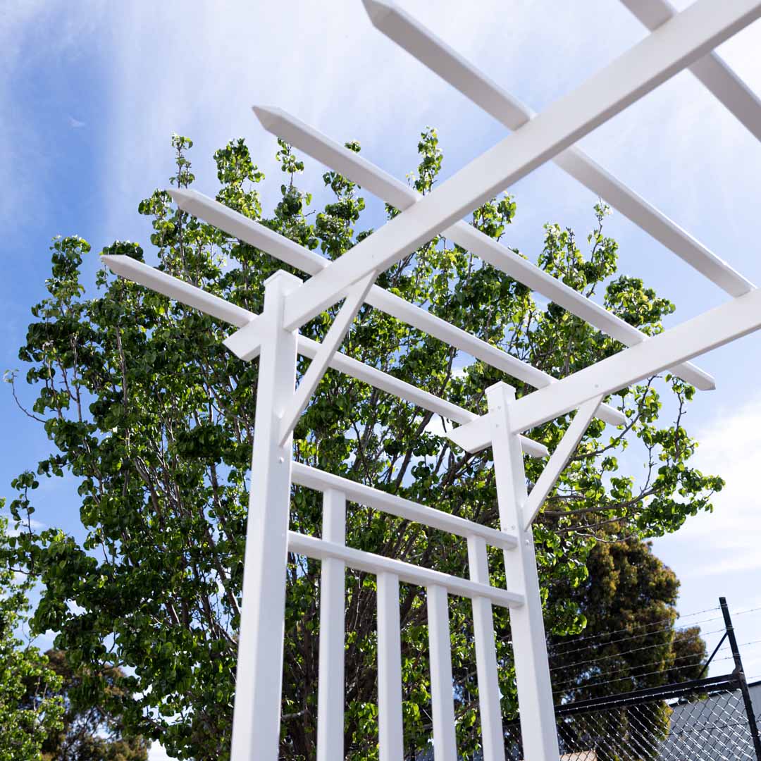 Close up of white PVC arbour roof showing cross beams and sturdy frame for wedding and event styling.