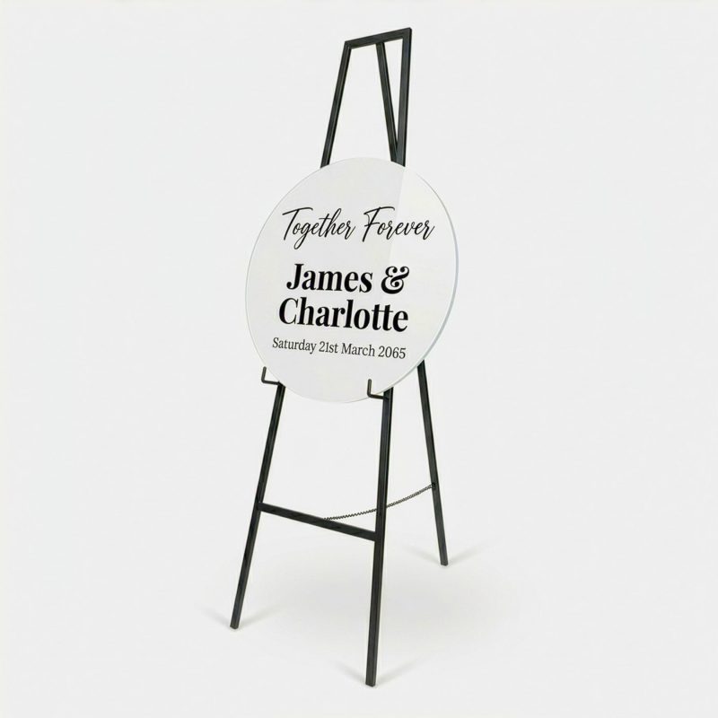 Custom round acrylic sign board displayed on black stand with wedding text